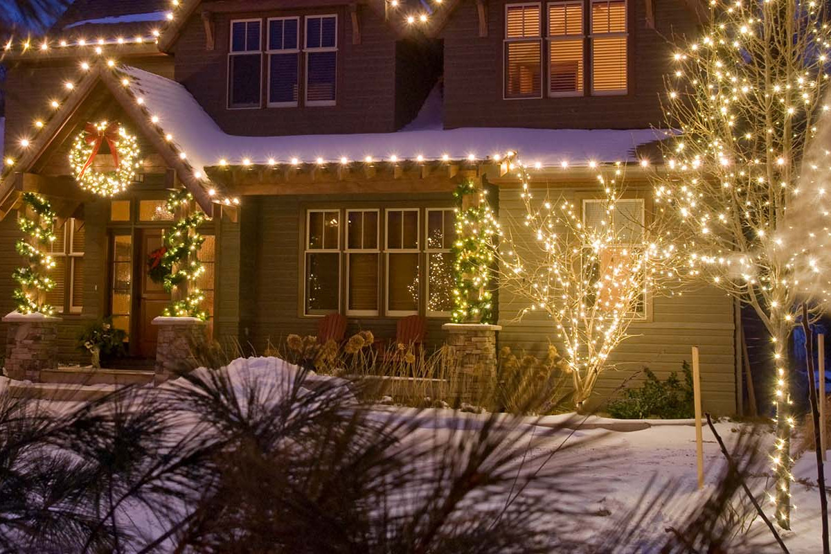 Christmas lights on house and trees